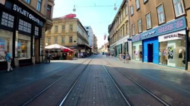 Tram network in Zagreb. Zagreb trams. Public transport in Croatia. Tram tracks in the center of Zagreb. Showcases with shops and restaurants. Capital of Croatia.