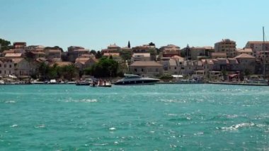 Panoramic view of the sea and the city in Trogir. Large yachts near the pier in Trogir Croatia. Embankment with boats in Trogir. Seascape in Croatia. Promenade along the sea.