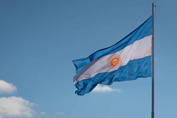 ARGENTINE FLAG FLYING TO THE LEFT. HORIZONTAL PHOTOGRAPH, COLOR.