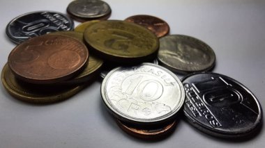 Silver 10 Cruzeiros coin with a collection of various old coins on a white background.