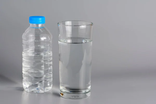 Glass with water on a white table.