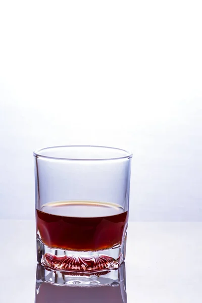 Glass of whiskey on a glass table