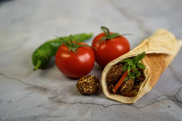 Falafel sandwich vegetarian food in a wrap flat Arabic bread.