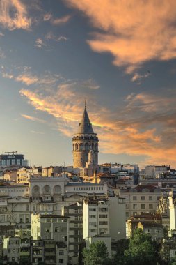 Cityscape of a part of Istanbul city showing homes and Galata tower at sunset 