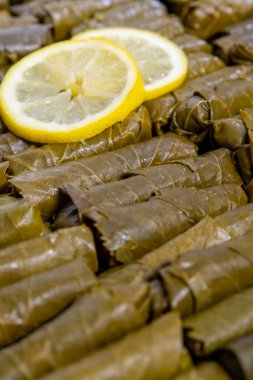 Grape leaves with parsley and lemons called Dolma , made from vines with rice, meat and spices.Filled view of delicious, stuffed 