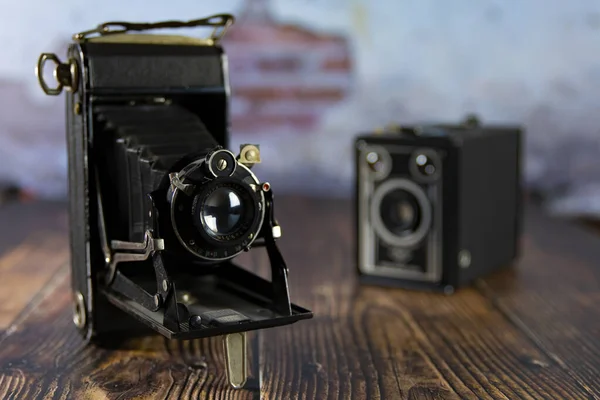 Old film camera on a wooden background, Box  cameras. photography Variety of old antique cameras. Still life