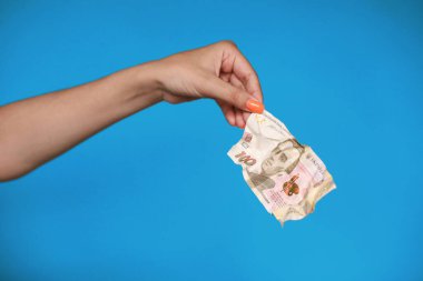 Kadın eli buruşuk Ukrayna Hryvnia 'sını tutuyor. Yüksek kalite fotoğraf