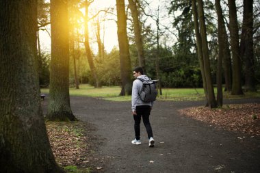 A man walks along a path among the park. High quality photo