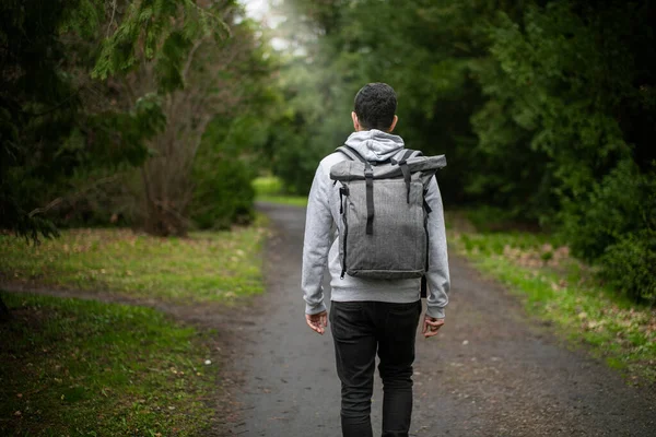 A man walks along a path among the park. High quality photo