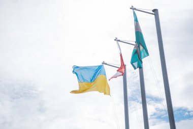 Poland, Warsaw - July 2022. Ukrainian flag on flagpole, near Poland flag. High quality photo