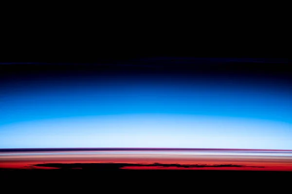 Blue earth horizon, World\'s atmosphere, Smoke in Stratosphere, Astronaut space photo of sunrises and sunsets. Elements of this image furnished by NASA