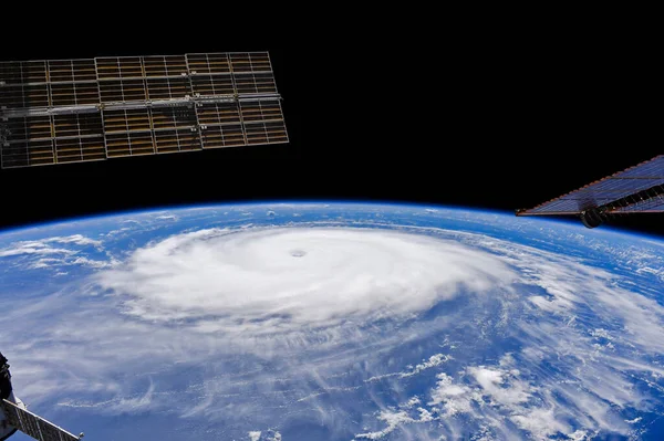 Hurricane Sam, category 4 storm spinning over the Atlantic Ocean, earth photo from space, top view of a storm, circular cloud, swirling white clouds in the sky.Elements of this image furnished by NASA