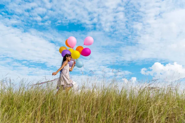 Cheerful Cute Girl Holding Balloons Running Green Meadow White Cloud — Stock Photo, Image