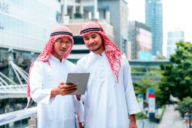 Arap takımı dijital tablet uae sendika elemanlarını tutuyor. Akıllı tablet kullanan dijital pazarlama Arap grubu modern Müslüman BAE şehrini tartışıyor. Girişimci Asyalı insanlar toplantı takımlarına gülümsüyor.