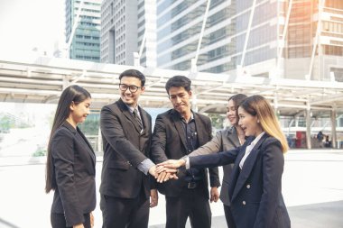 Çoklu Etnik Takım Çalışması Dostluk Grubu birlikte beyin fırtınası yapıyor. İş adamları dayanışma için el ele tutuşuyor. Çeşitlilik, iş ortağı takım çalışması. Ebeleme ekibinin gücünü bir arada tutan takım çalışması.