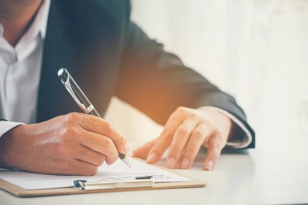 Businessman hand using pen signing on new contract to starting projects in conference room. Close up business manager man hands sign contract legal document in meeting room. Business agreement concept