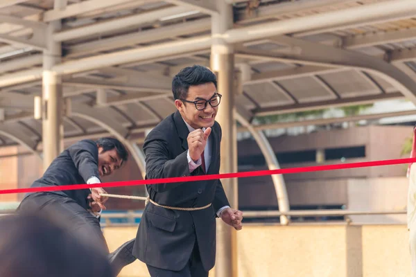 Competitive person race to be first place winner. Multiethnic diversity people contest. Business competition group of business people in formal suit run to finish line success goal victory concept