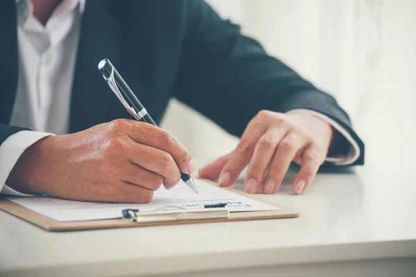 Businessman hand using pen signing on new contract to starting projects in conference room. Close up business manager man hands sign contract legal document in meeting room. Business agreement concept