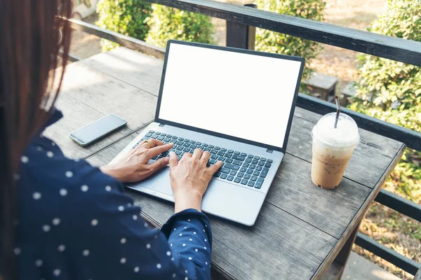 Empty Screen laptop Blogger Woman hands typing computer keyboard. Close up women hands using laptop sitting at coffee shop garden. Top view Freelance woman working type computer keyboard Blank screen