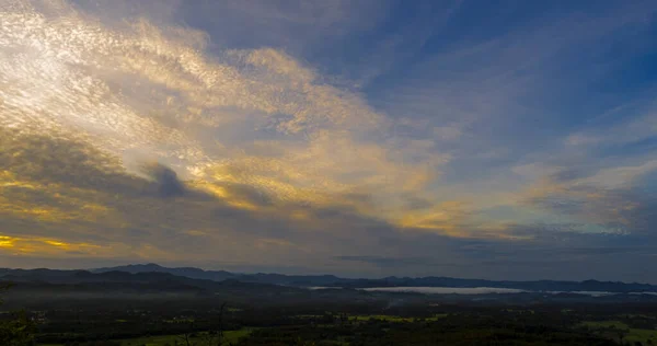 Blue golden sky sunrise dramatic beautiful landscape mountain. Dawn sky gold dusk time cloudscape with sunlight. Dramatic sunset over mountain landscape. Beautiful landscape foggy hills twilight time