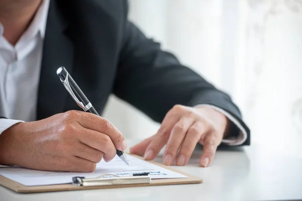 Businessman hand using pen signing on new contract to starting projects in conference room. Close up business manager man hands sign contract legal document in meeting room. Business agreement concept