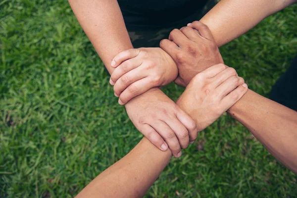 Close up hands Diverse multiethnic Partners team together. Teamwork group of multi racial people meeting join hands. Diversity people hands join empower partnership teams connect volunteer community