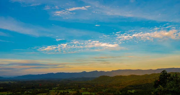 Blue golden sky sunrise dramatic beautiful landscape mountain. Dawn sky gold dusk time cloudscape with sunlight. Dramatic sunset over mountain landscape. Beautiful landscape foggy hills twilight time