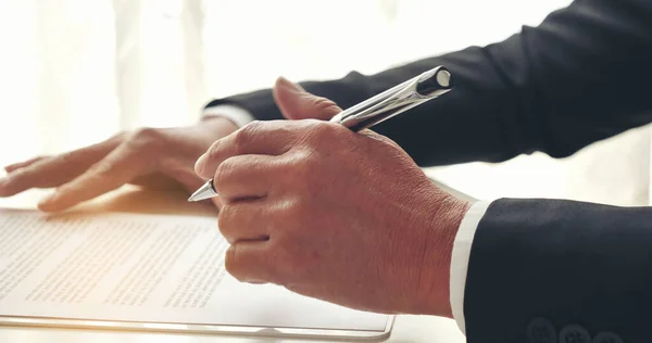 Asian business man using pen signing on new contract to starting projects in conference room. Close up manager businessman hands sign contract working meeting. Business agreement concepts.