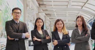 Portrait Group of businesspeople arms crossed smiling look at camera in modern city background. Happy Businessman, businesswoman teams partnership. Business people teams positive teamwork standing.