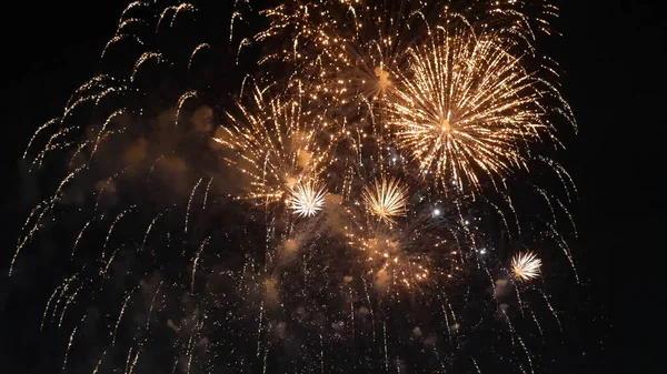 Golden Firework celebrate anniversary happy new year 2023, 4th of july holiday festival. Gold firework in the night time celebrate national holiday. Countdown to new year 2023 gold party time event