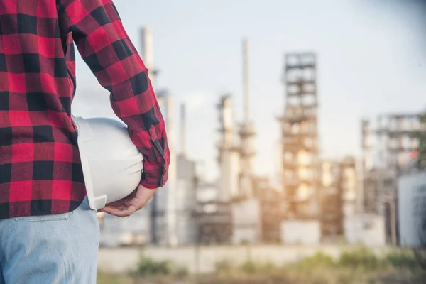 Refinery woman engineer oil industry hands hold worker helmet hard hat. Refinery industry engineering. Engineer woman hands holding hardhat white work helmet hard hat for Construction Engineering