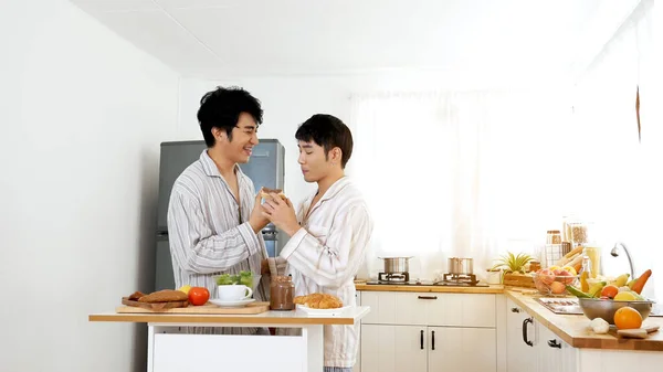 Happiness romance homosexual marriage lifestyle. Two men together love friendship. Happy gay couple enjoy breakfast in kitchen drinking coffee. Two best friends LGBTQ relation partner home cooking