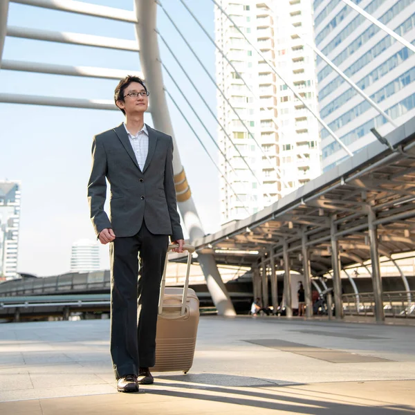 Asian businessman wear suit, eye glasses standing street in modern city. Portrait Young handsome asian man look at bright future smart, confident. Entrepreneur executive man cityscape outside office
