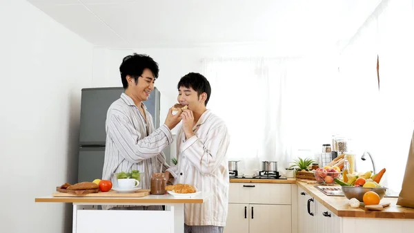 Happiness romance homosexual marriage lifestyle. Two men together love friendship. Happy gay couple enjoy breakfast in kitchen drinking coffee. Two best friends LGBTQ relation partner home cooking