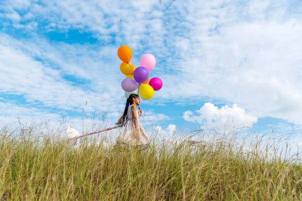 Cheerful Cute Girl Holding Balloons Running Green Meadow White Cloud — Stock Photo, Image