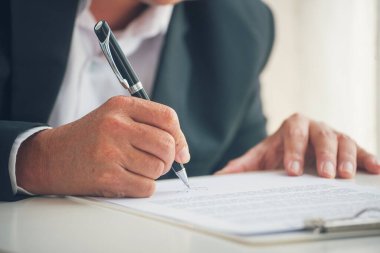 Asian business man using pen signing on new contract to starting projects in conference room. Close up manager businessman hands sign contract working meeting. Business agreement concepts.