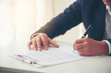 Asian business man using pen signing on new contract to starting projects in conference room. Close up manager businessman hands sign contract working meeting. Business agreement concepts.
