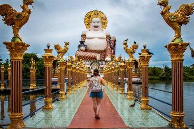 Koh Samui, Tayland 'da Büyük Buda' da geri geri yürüyen bir turist. Koh Samui 'deki Büyük Buda' nın ihtişamına hayran olan bir turist..