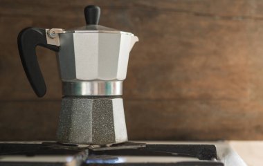 Turk coffee maker stands on a gas stove. Visible fire