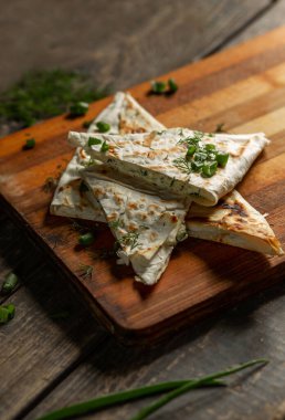 Bir tabak süzme peynir maydanozlu ve ızgarada kızartılmış pita ekmeğinde soğan.