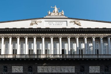 Naples, Italy. May 28, 2022. Top part of Real Teatro di San Carlo (Royal Theatre of Saint Charles) , an opera house in Naples, Italy with clear blue sky.