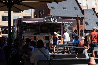 Copenhagen, Denmark. August 13, 2022. Crepe stall in Broens Gadekokken, the street food area in Copenhagen harbour with people sitting at the tables