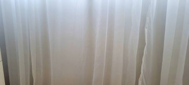 white curtain illuminated by sunlight used as a background