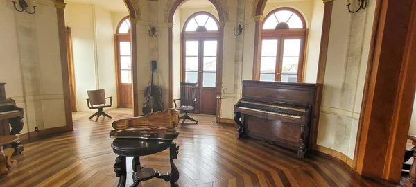 music room with classical piano violin and old cello in museum in the countryside of Brazil