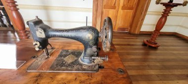 antique black sewing machine with wood finish, in a museum in brazil