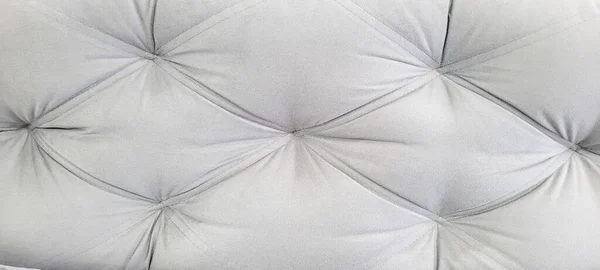 soft foam sofa with folded, gray stitched