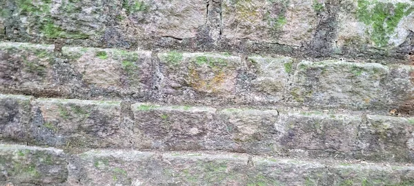 old brick wall of dark stones, which can be used as a background