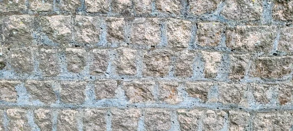 old brick wall of dark stones, which can be used as a background