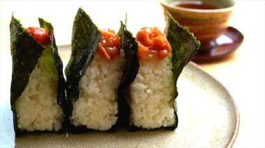 Onigiri Nori 'ye sarılmış, umeboshi' de üstte.