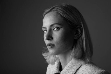 Black and white portrait of young woman looking at the camera. Isolated.